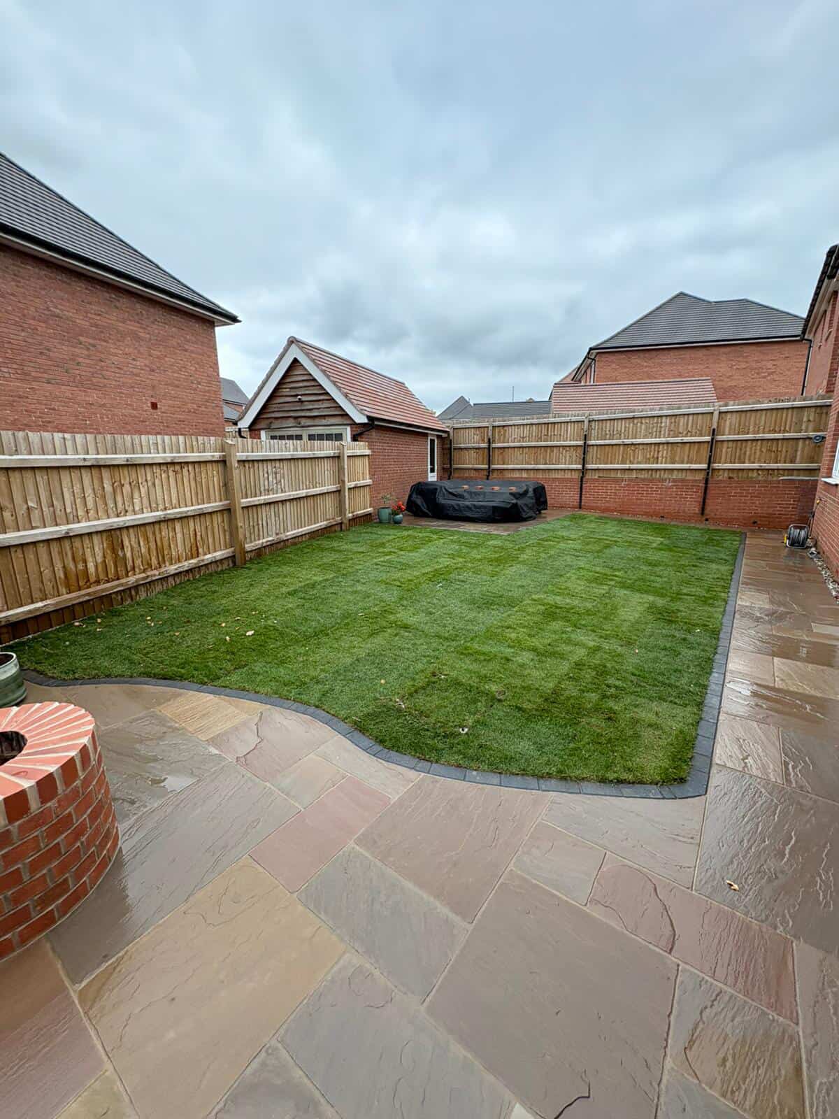 Full garden transformation with sandstone patio and new lawn